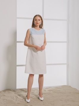 White dress with blue cross-stitching
